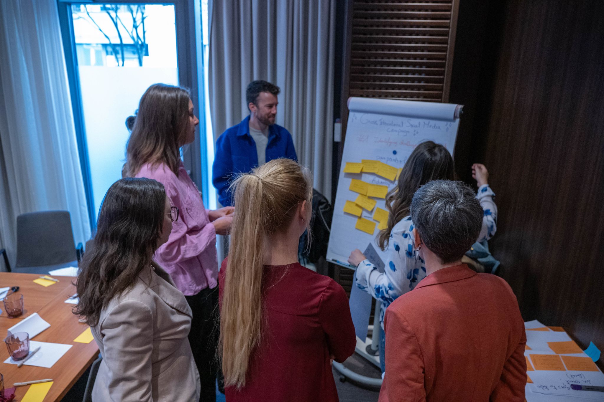 International team taking part in a collaborative social media workshop in Berlin